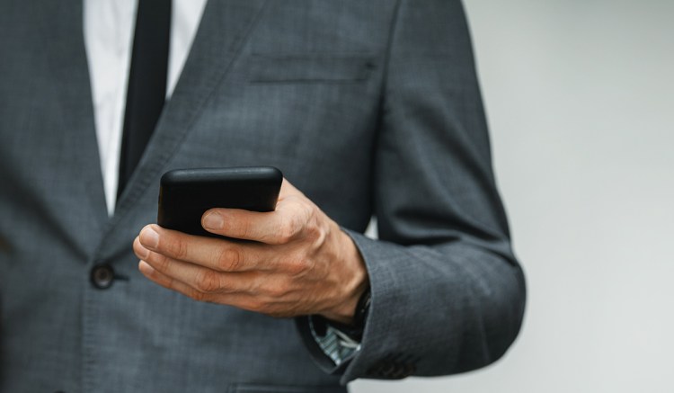 A man uses his phone to send unauthorized communications