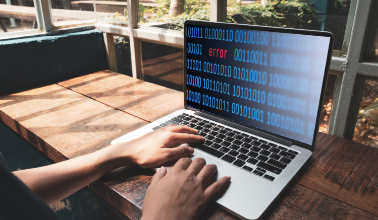 A man types at a computer to avoid operational resilience failures