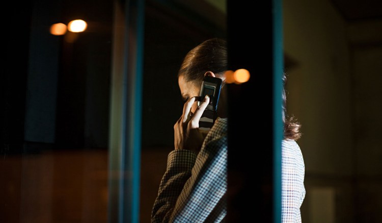 A woman talks on the phone using illicit communications