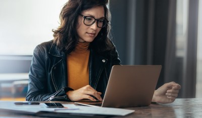 This image features a compliance reviewer determining the main compliance takeaways of the the FCA's AI Adoption Plan.
